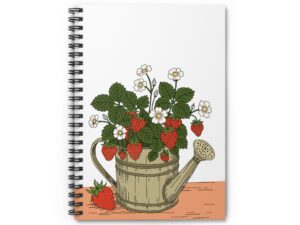 Spiral notebook featuring strawberry plants growing from a watering can with red berries, white flowers, green leaves, and cottage garden artwork.