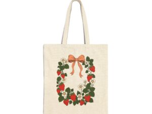 Cotton canvas tote bag featuring strawberry wreath artwork with red strawberries, white flowers, green leaves, leafy vines, and a bow in cottage garden style.