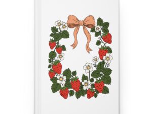 Matte hardcover journal featuring strawberry wreath artwork with red berries, white flowers, green leaves, and a soft bow in a cottage garden style.