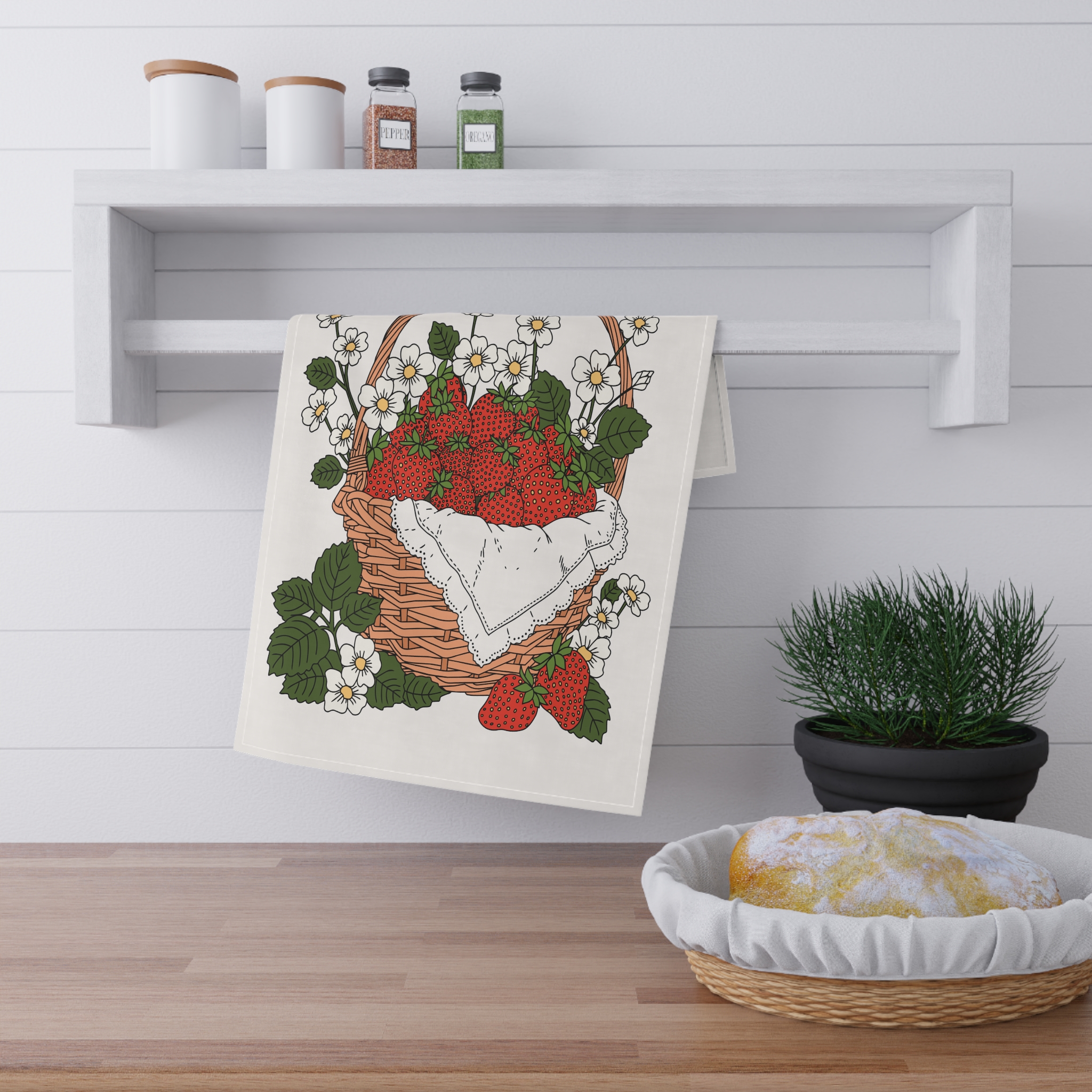 Illustrated strawberry basket tea towel design featuring red strawberries, white flowers, green leaves, and a woven basket in a cozy cottage garden style.