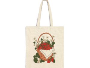 Cotton canvas tote bag featuring strawberry basket artwork with illustrated red berries, white flowers, green leaves, and cottage garden details.